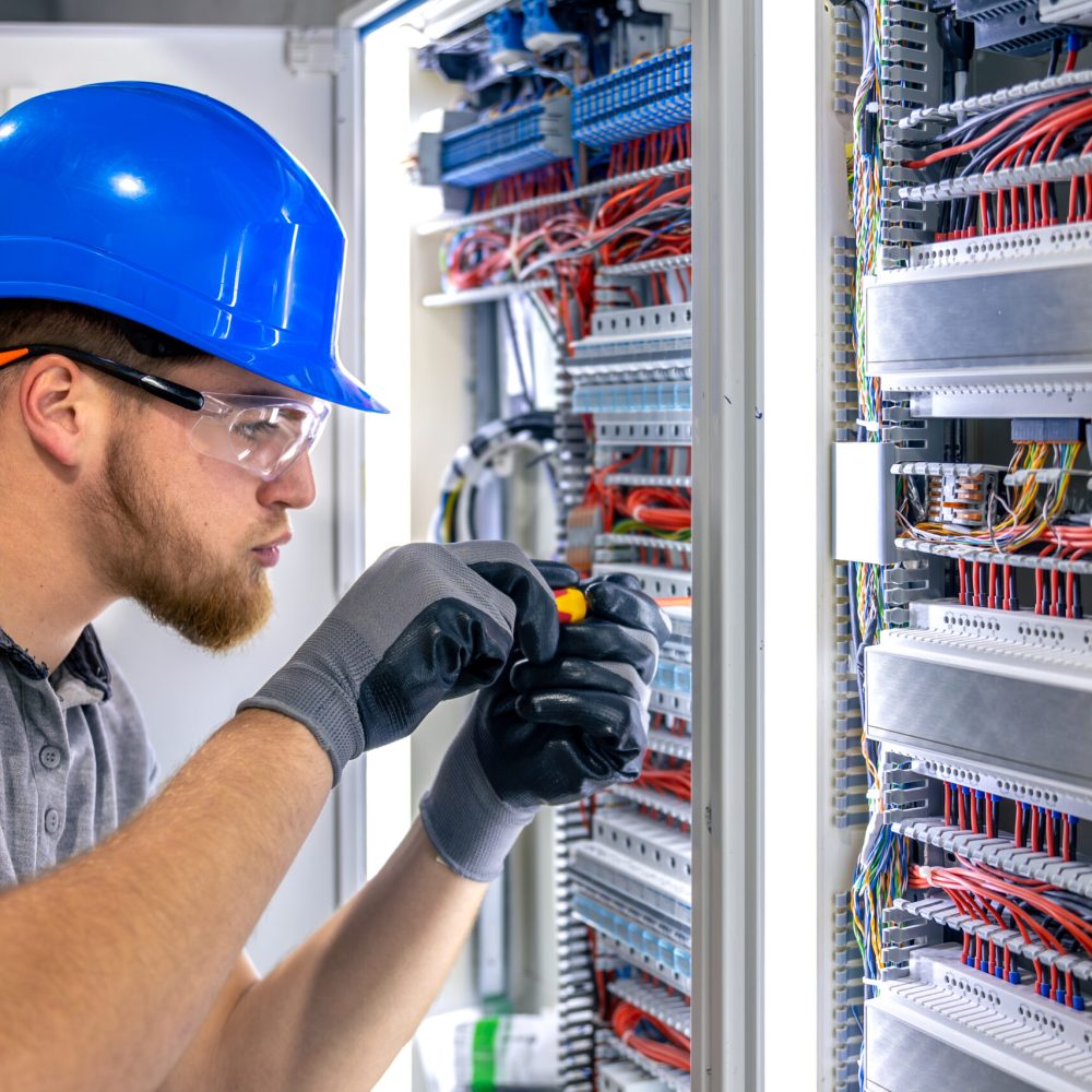 Male electrician in uniform working in a switchboard. Electricity. High quality photo. Male electrician in hard hat. A male electrician solves a problem with electricity. SSUCv3H4sIAAAAAAAAA41Py46DMAz8F5+DZEgfkF+pegjEpVaBVInTaoXy76tQqr3ubcb2PLwCOzCgu/bsThar5oDnqq5vWPVD01QH3enjUXdkbw4UOCsEpta6Q92i1m2HJ0REBb2NPIBZgacpRQlW2C9gUEGgxVHYIDkWH9hOYDAriGIlRYpg1qxgsEKjD7zxr99lLXMwAApi6gvI6p+zqwI70jL8FP9cikxkt7jLVcHjLRTmPdvLvVQs8Bl44GXcO6Uofv7gxUvRbgnihwe7Xfx5485RfChZkJ6Tt47cvk79zCJfGujF9P67zjn/AtX+mMaEAQAA
